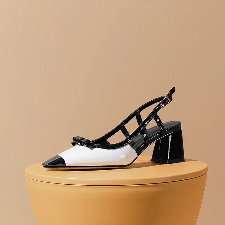 Black and white high-heeled shoes on a beige background