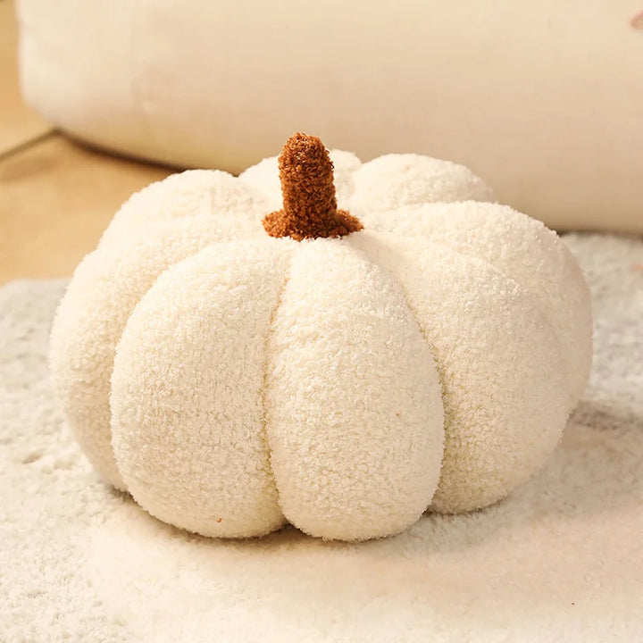 White pumpkin with a brown stem on a textured surface