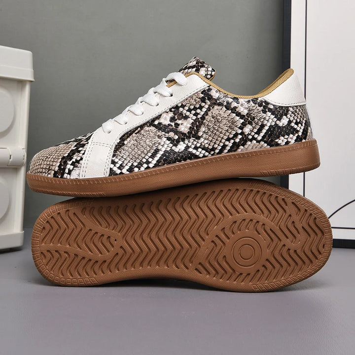 Sneaker with snake print pattern on a gray background