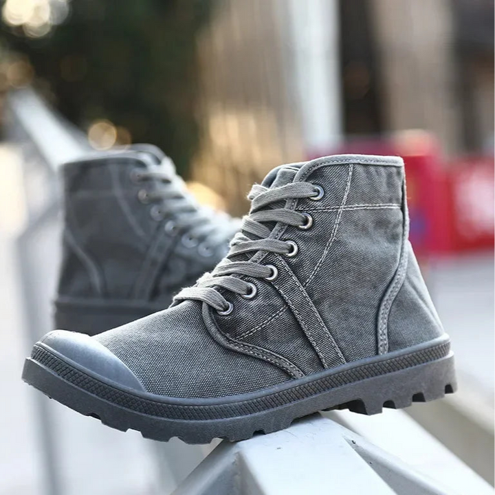 Gray high-top boots with black soles on a blurred background