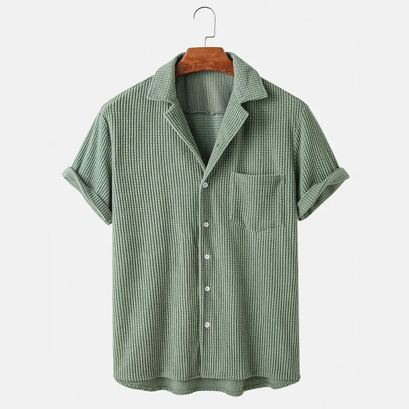 Green checkered shirt on a hanger against a white background