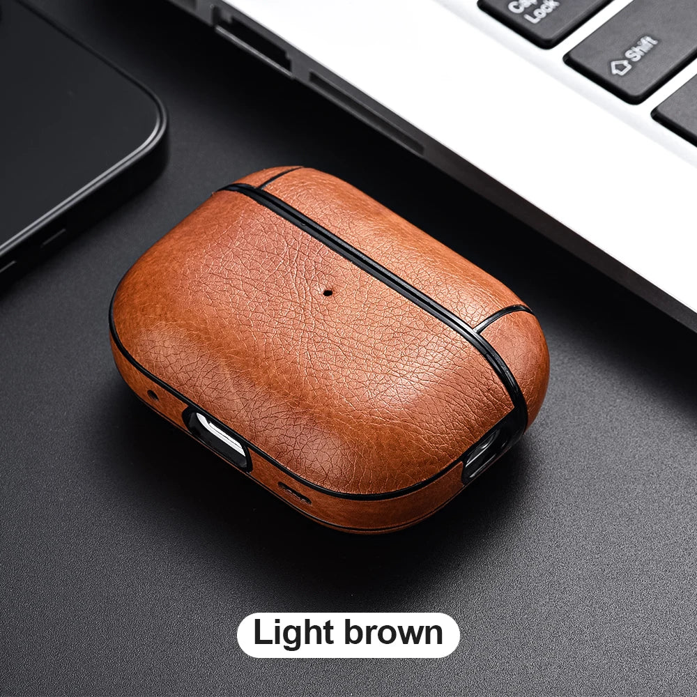 Light brown leather case on a dark surface with a laptop in the background