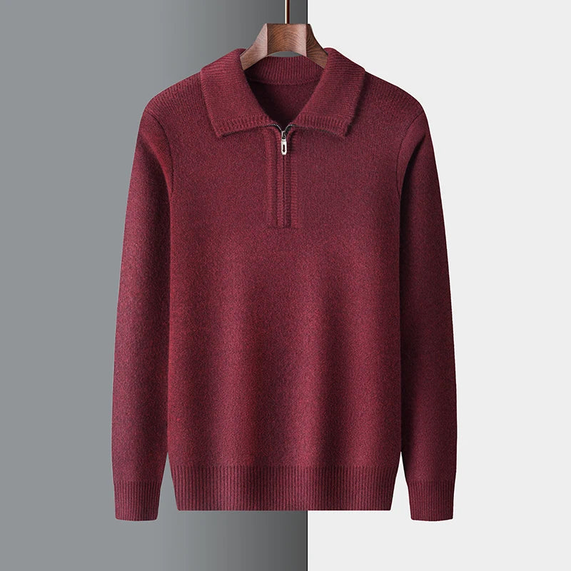 Maroon sweater with a quarter zip on a hanger against a gray background