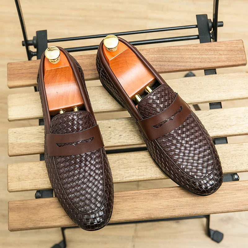 Brown woven loafers on a wooden surface