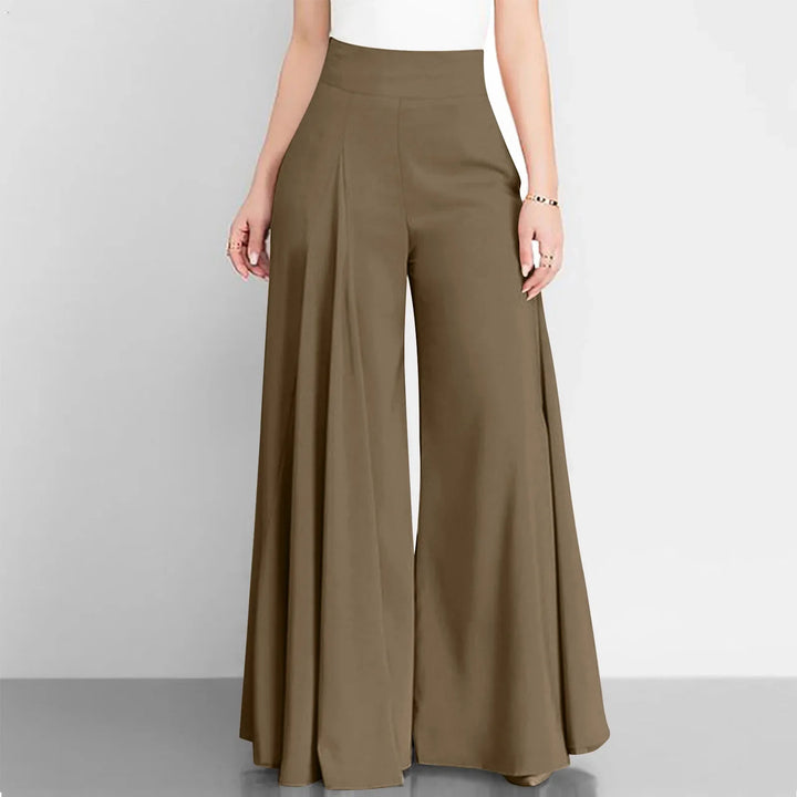 Brown wide-leg pants worn by a person on a gray background