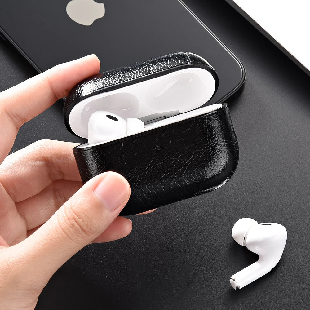 Black leather case with white wireless earbuds on a black surface with Apple logo.