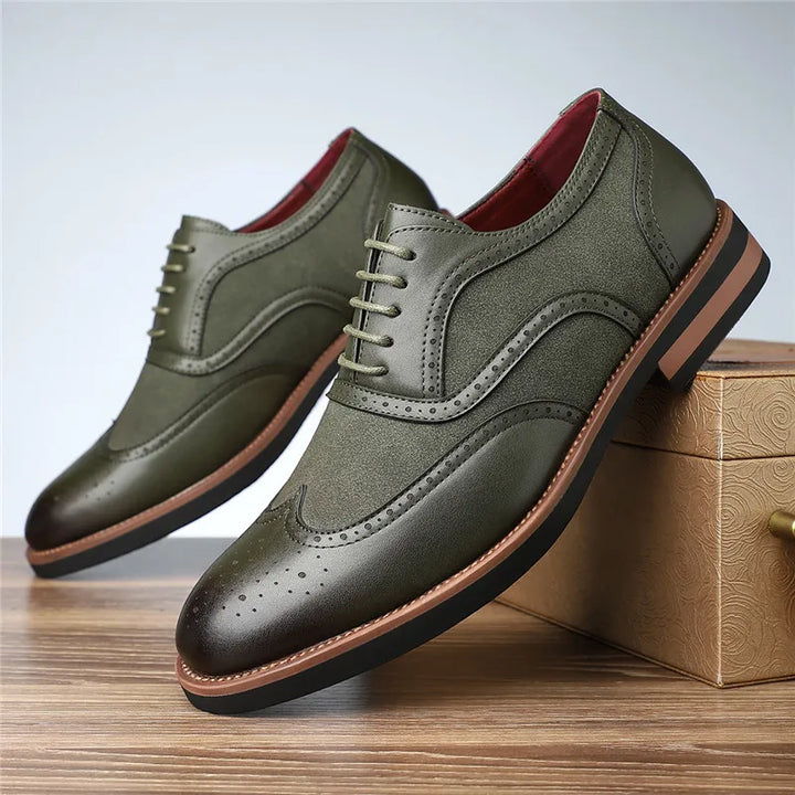 Green leather shoes with brown soles on a wooden surface