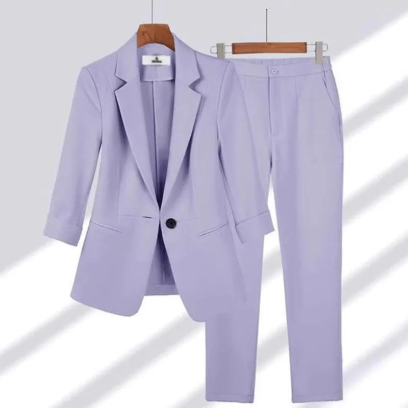Lavender suit with a blazer and pants on hangers against a white background