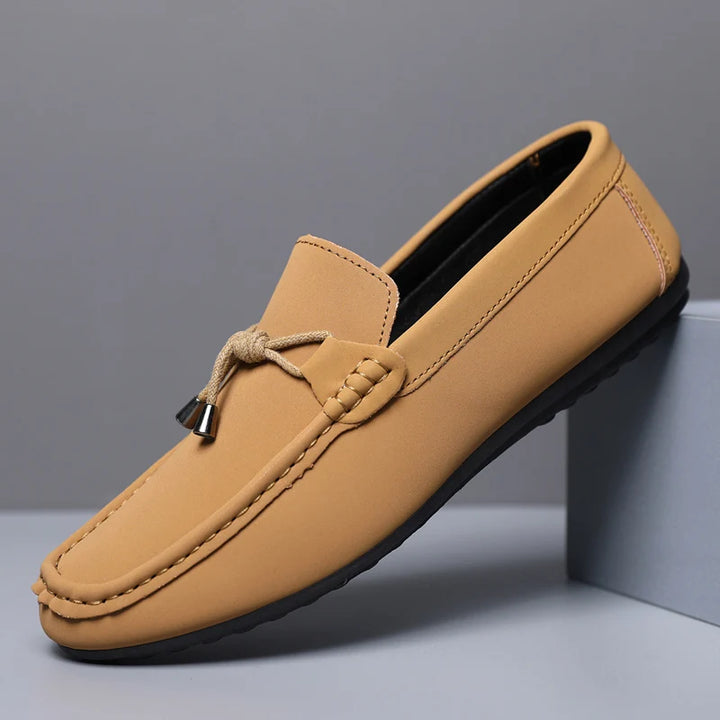 Tan loafer shoe on a gray background