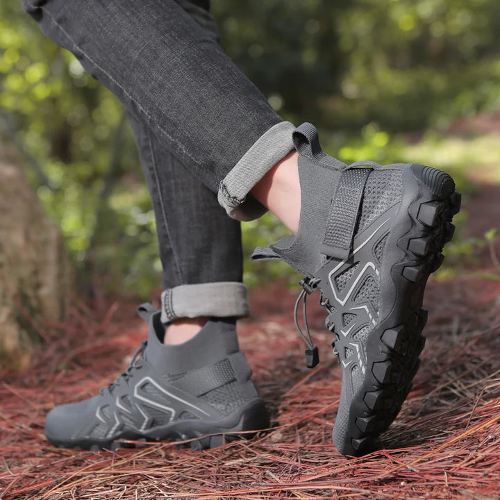 Person wearing gray hiking boots on a natural outdoor setting