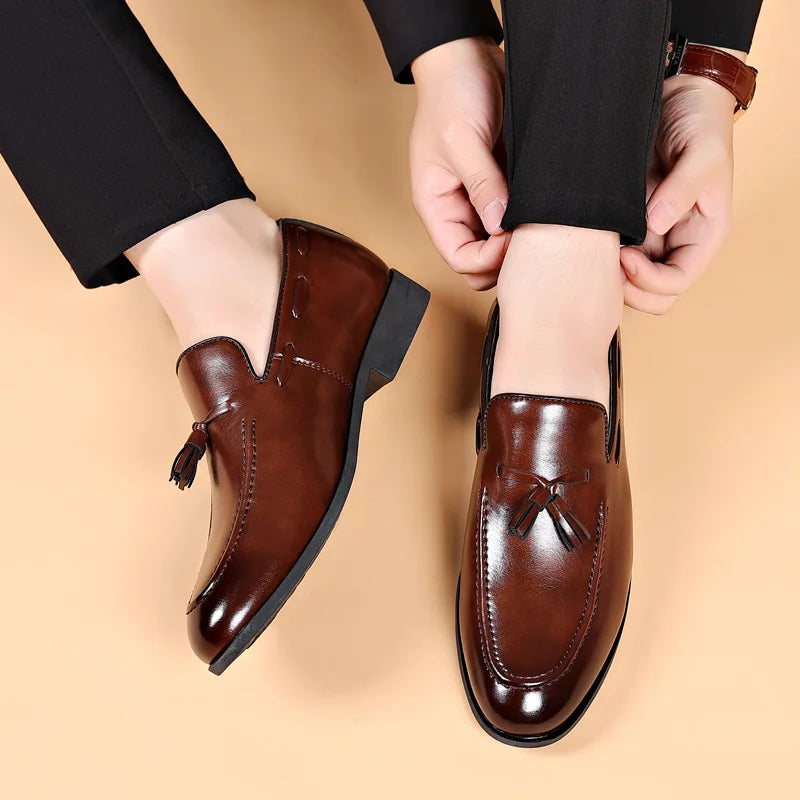 Brown leather shoes being worn on a beige background