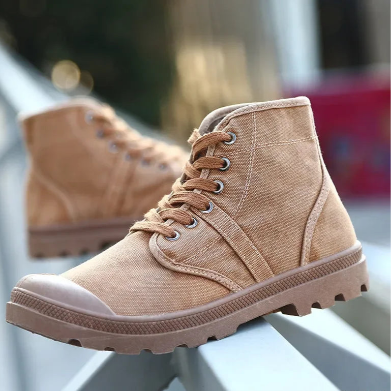 Tan high-top sneakers with white soles on a blurred background