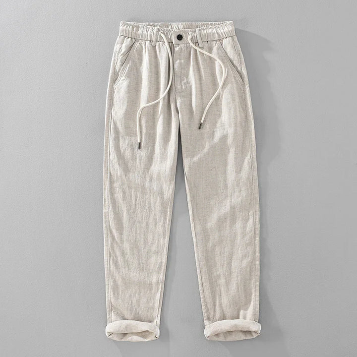 Beige pants with drawstring on a gray background