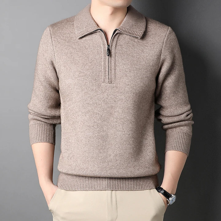 Beige sweater with a quarter zip on a gray background