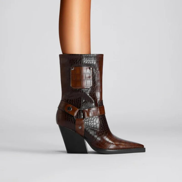 Brown crocodile-patterned boot with a black heel on a light gray background