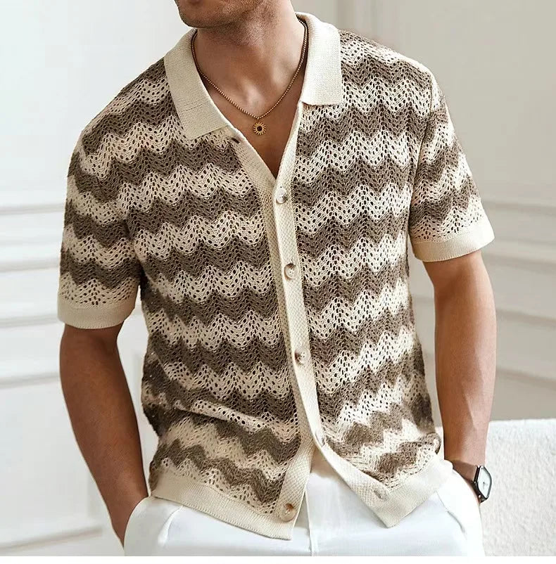 Man wearing a patterned shirt with a blurred background