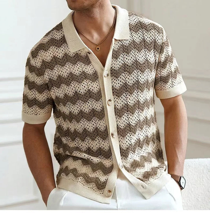 Man wearing a patterned shirt with a blurred background