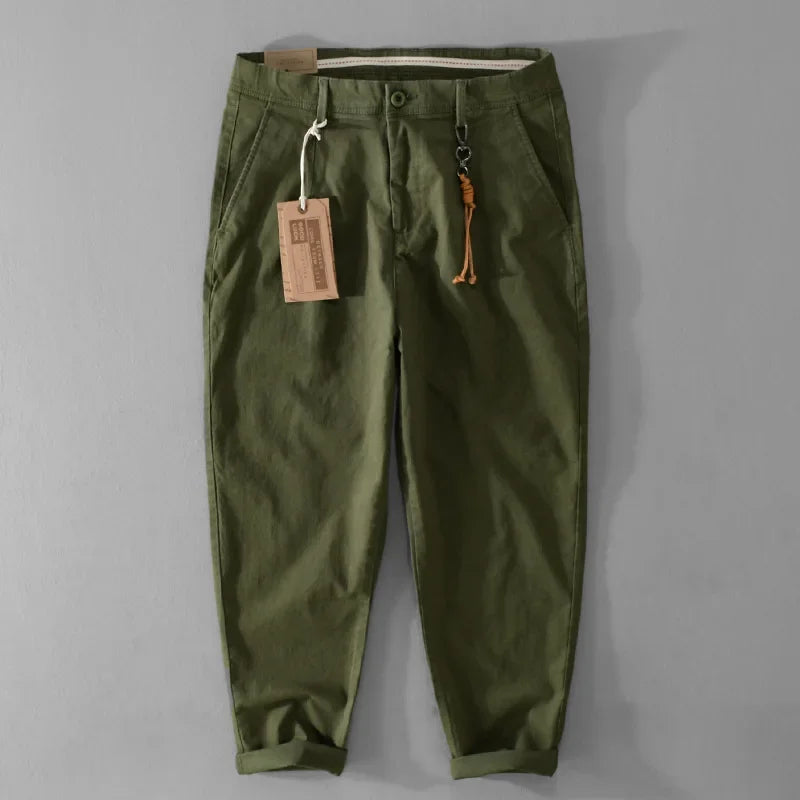 Green pants with a tag on a gray background