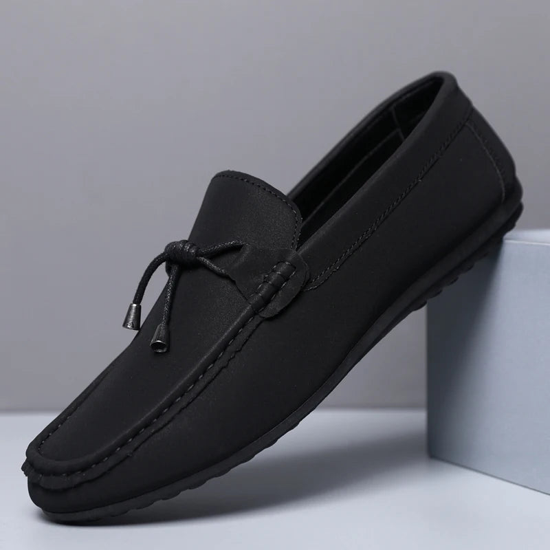 Black loafer shoe on a light gray background