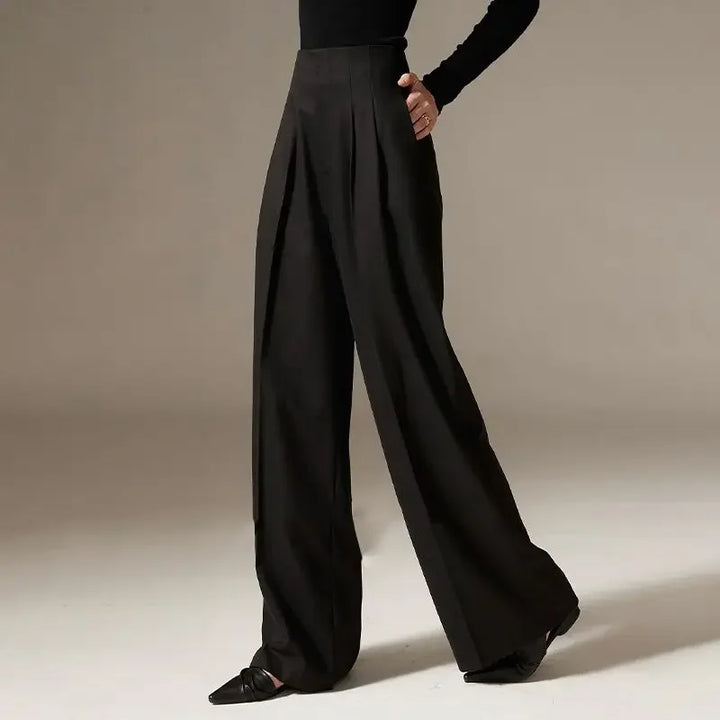 Black wide-leg pants worn by a person on a neutral background