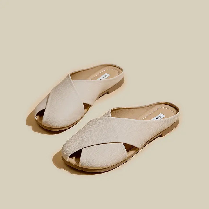 Pair of beige sandals on a beige background