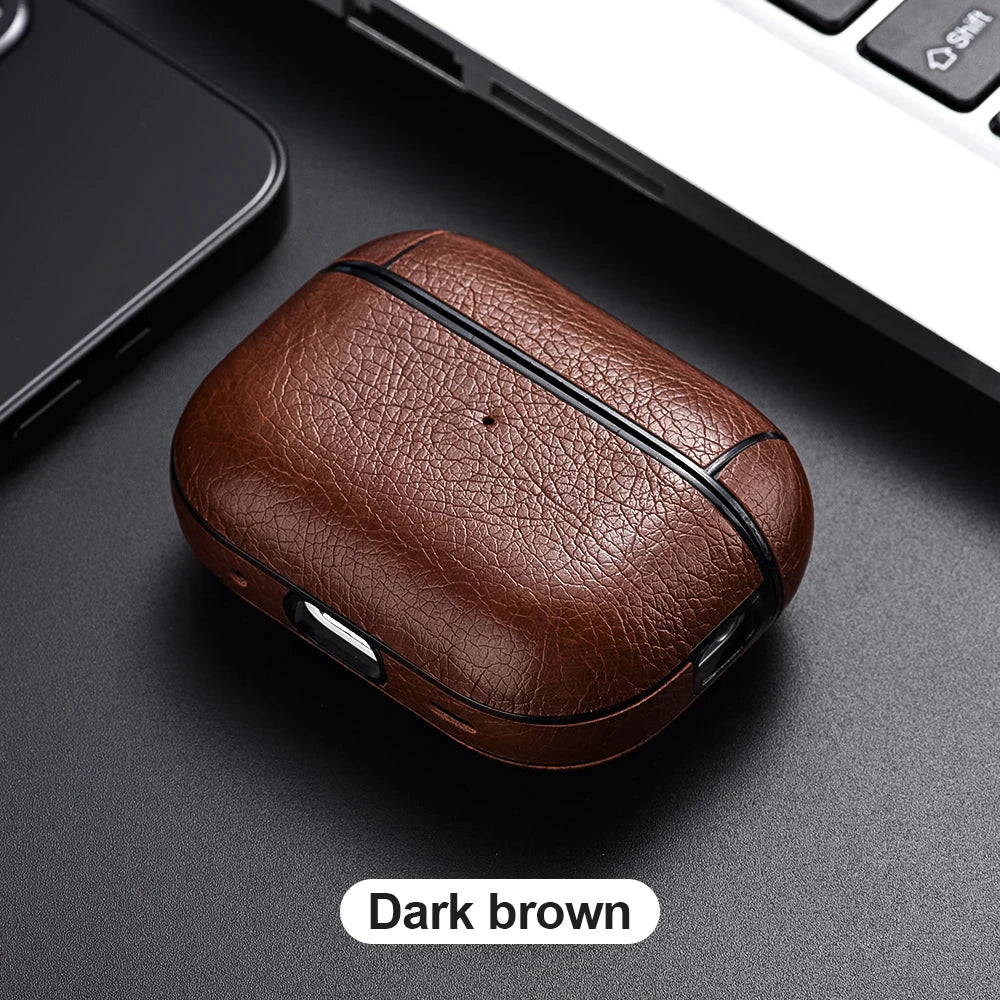 Dark brown leather case on a dark surface with a blurred laptop and phone in the background.