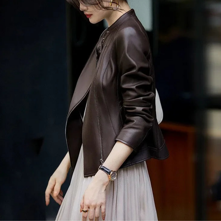 Woman wearing a brown leather jacket in an indoor setting