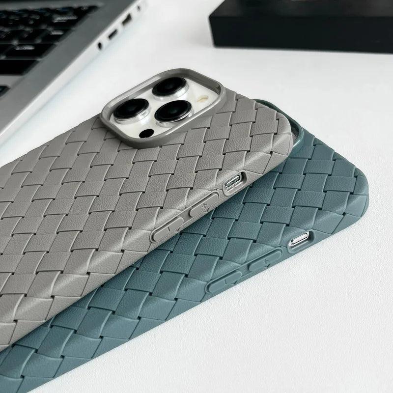 Two woven phone cases, one gray and one blue, on a white surface with a blurred background.