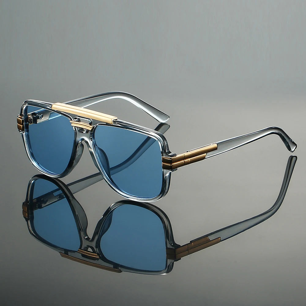 Sunglasses with gold accents on a reflective gray surface