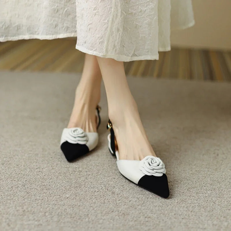 White shoes with black accents worn by a person on a carpeted floor.