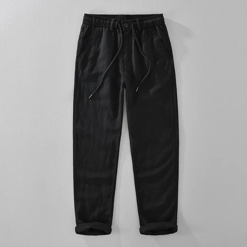 Black pants with drawstring on a light gray background