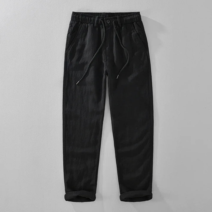 Black pants with drawstring on a light gray background
