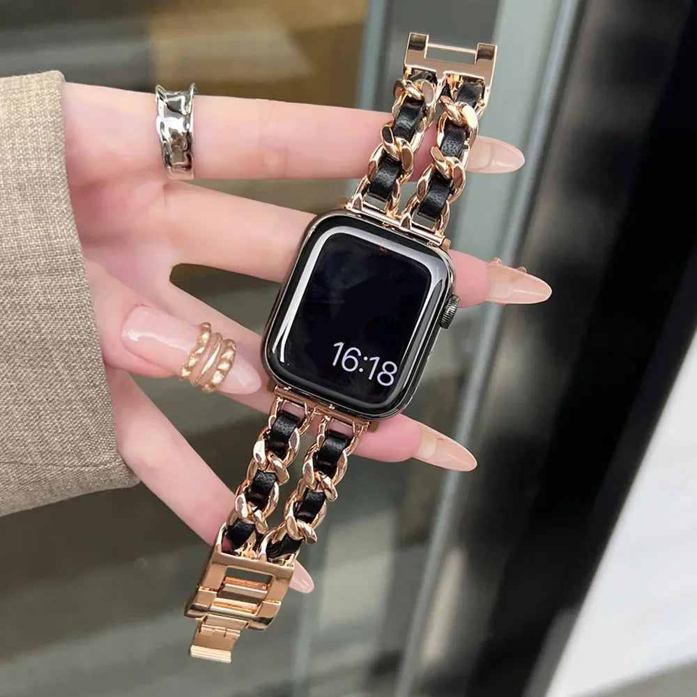 Smartwatch with a gold chain strap held by a hand