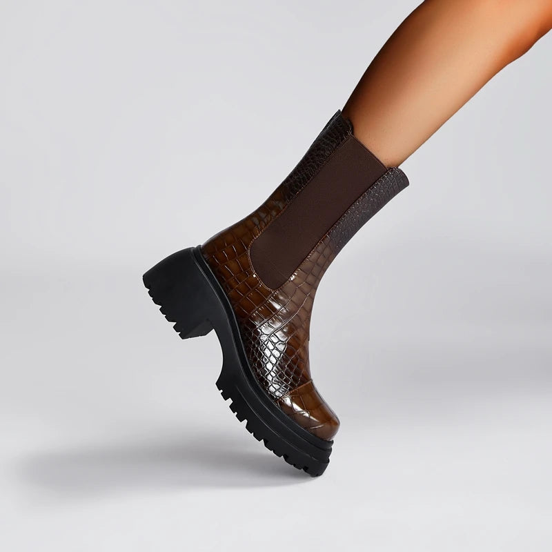 Brown crocodile-patterned platform shoe on a light gray background