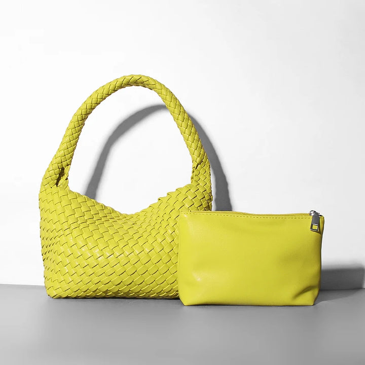 Yellow woven handbag and pouch on a light gray background