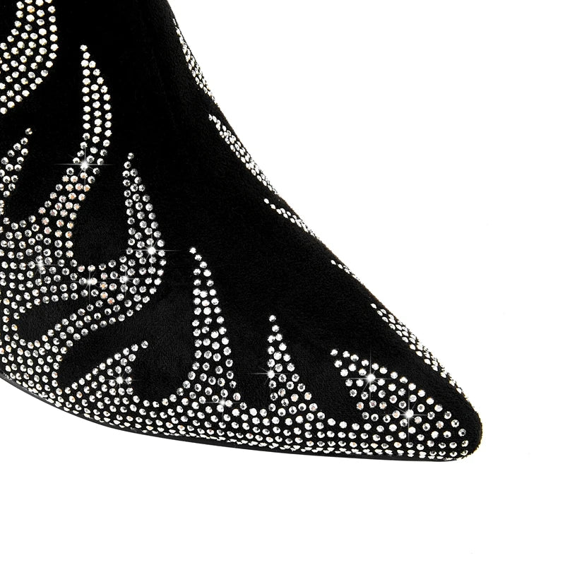 Black high-heeled shoe with rhinestone embellishments on a white background