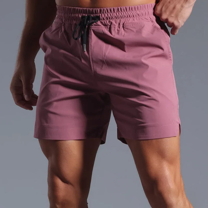 Purple shorts worn by a person on a gray background