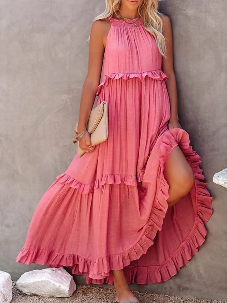 Woman wearing a pink ruffled dress against a neutral background