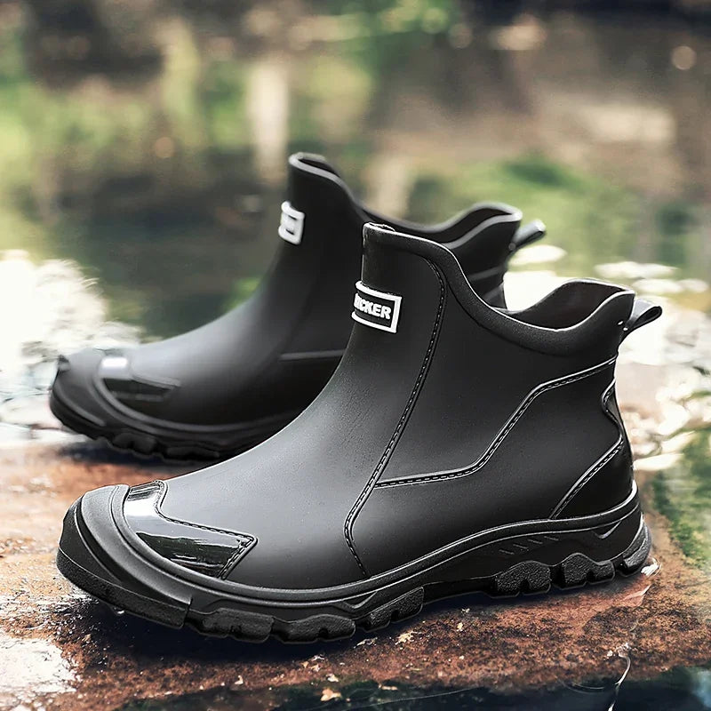 Black rubber boots with brand logo on a reflective surface