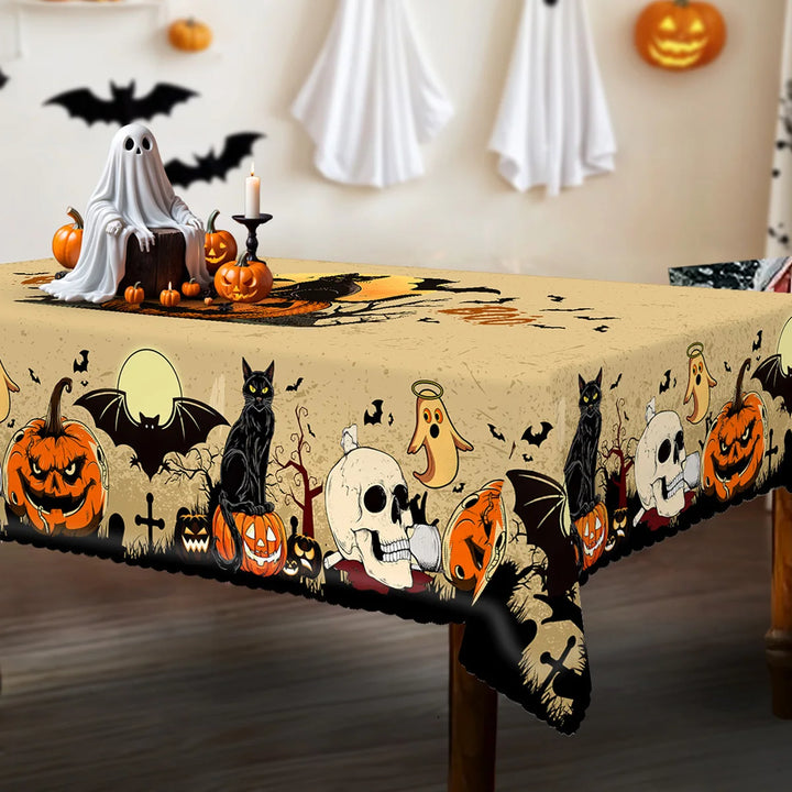 Halloween-themed tablecloth with pumpkins, ghosts, and cats on a decorated table.