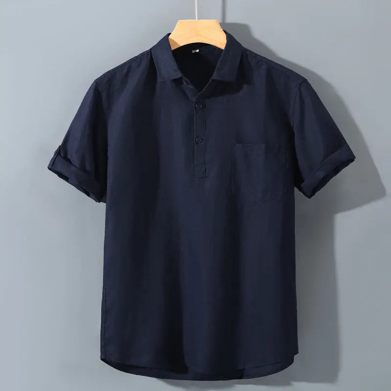 Navy blue polo shirt on a hanger against a gray background