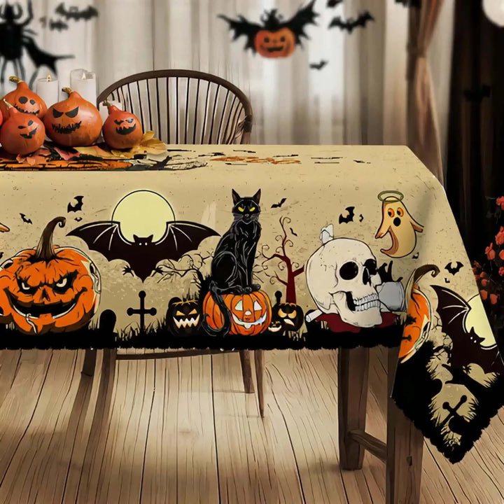 Halloween-themed tablecloth with pumpkins, cats, and ghosts on a wooden table.