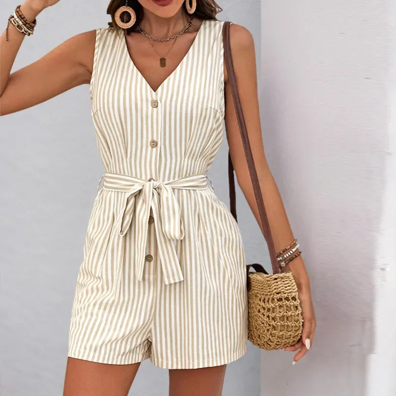 Woman wearing a striped romper with a plain background