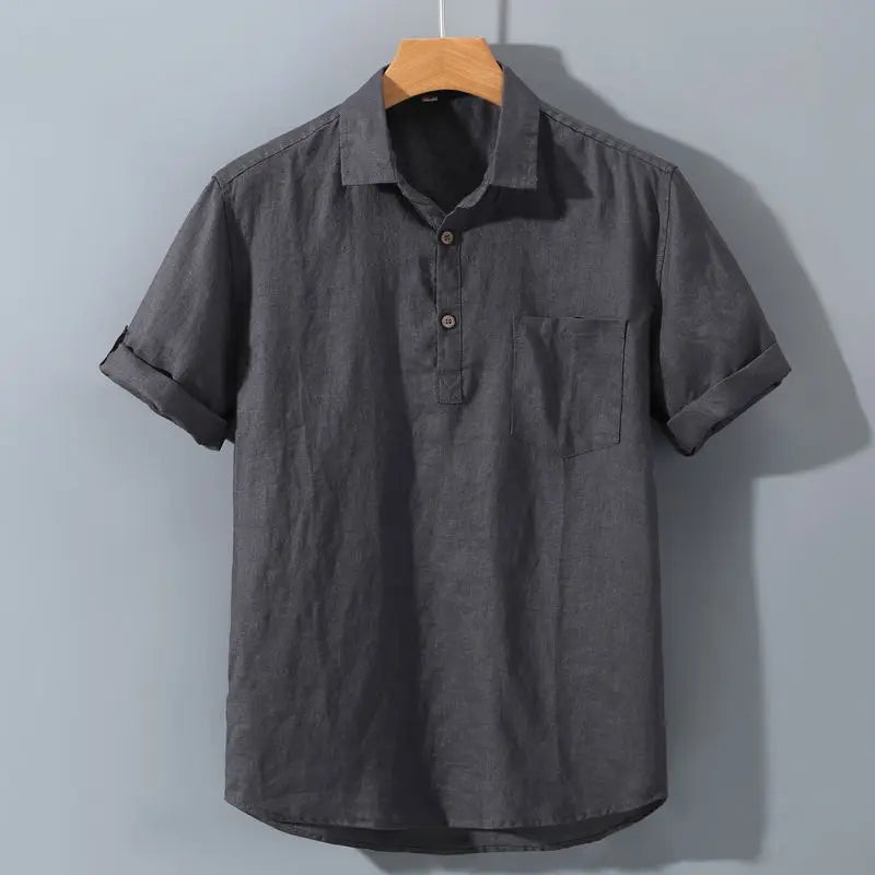Gray short-sleeve shirt on a wooden hanger against a light gray background