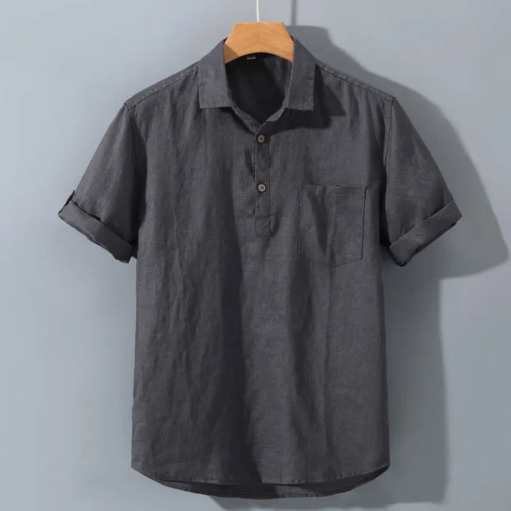 Gray short-sleeve shirt on a wooden hanger against a light gray background