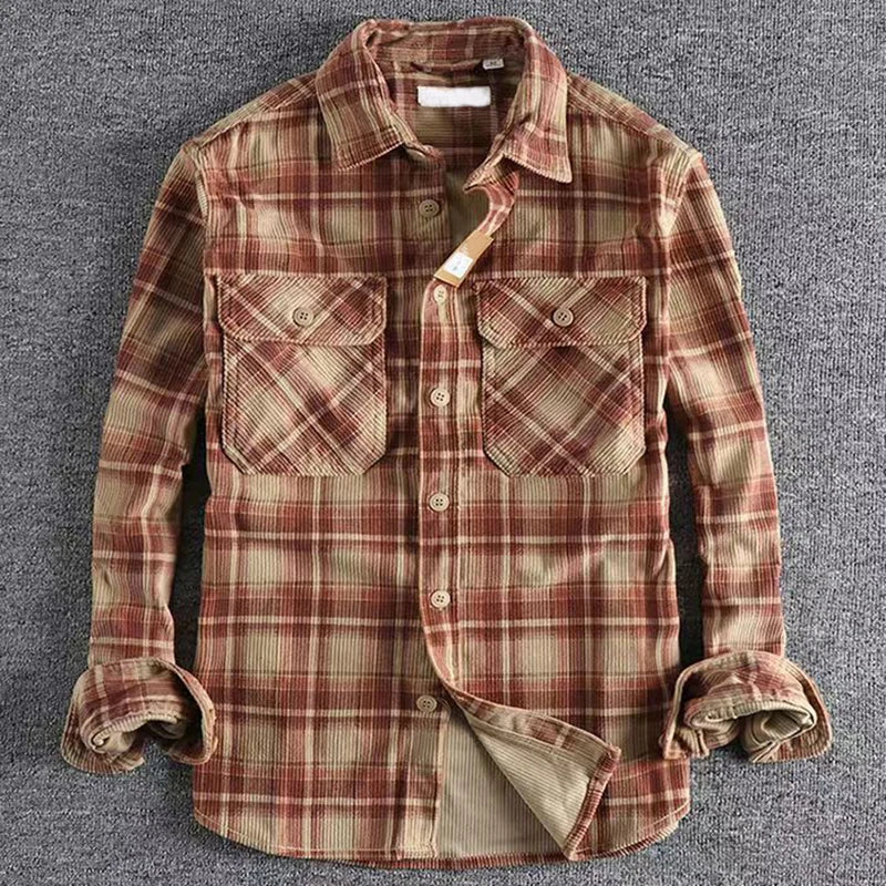 Plaid shirt with rolled-up sleeves on a gray background