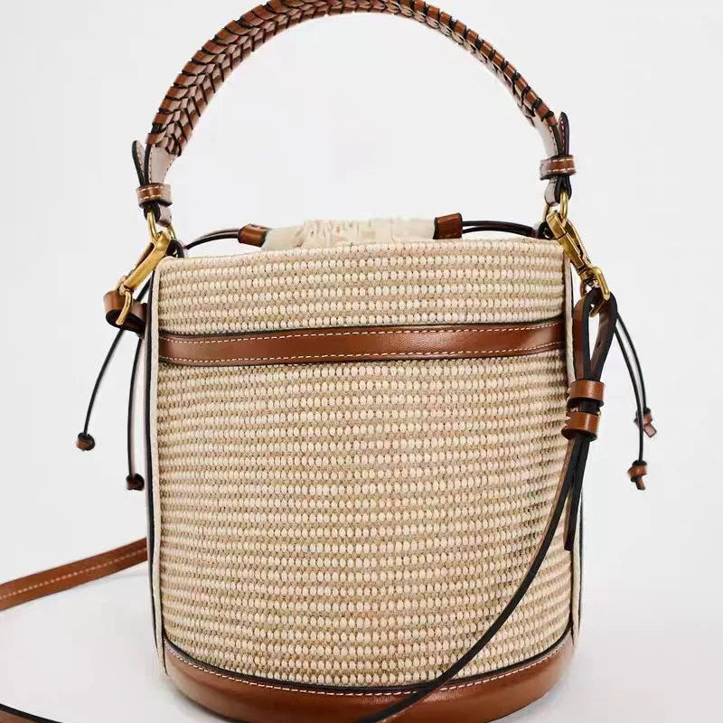 Woven handbag with brown leather accents on a white background