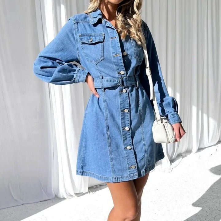 Woman wearing a blue denim dress with a white background