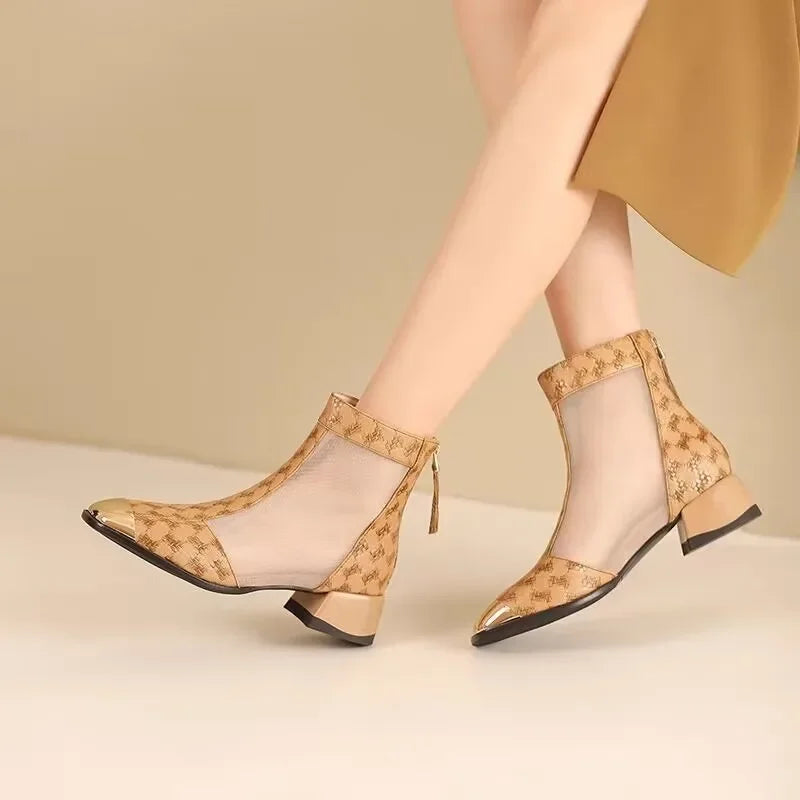 Beige open-toe shoes with floral pattern worn by a person on a beige background