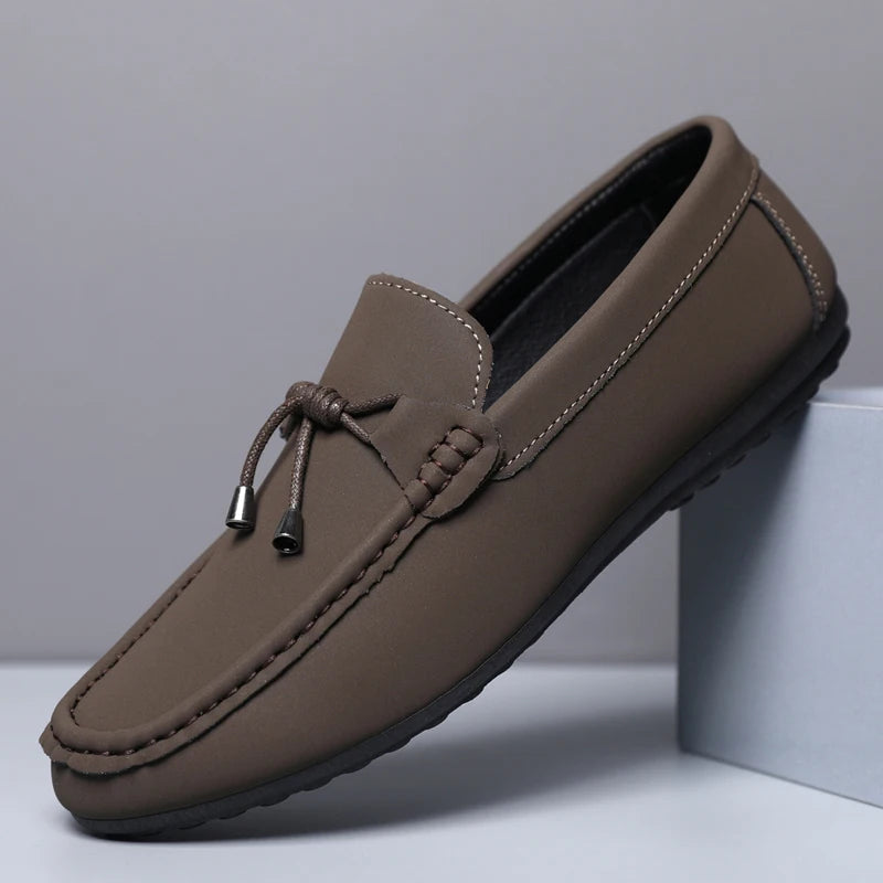 Brown loafer shoe on a light gray background